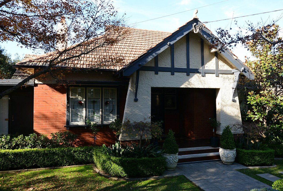 A Federation Arts and Crafts house with a low hedge and front garden on Shirley Road, Roseville