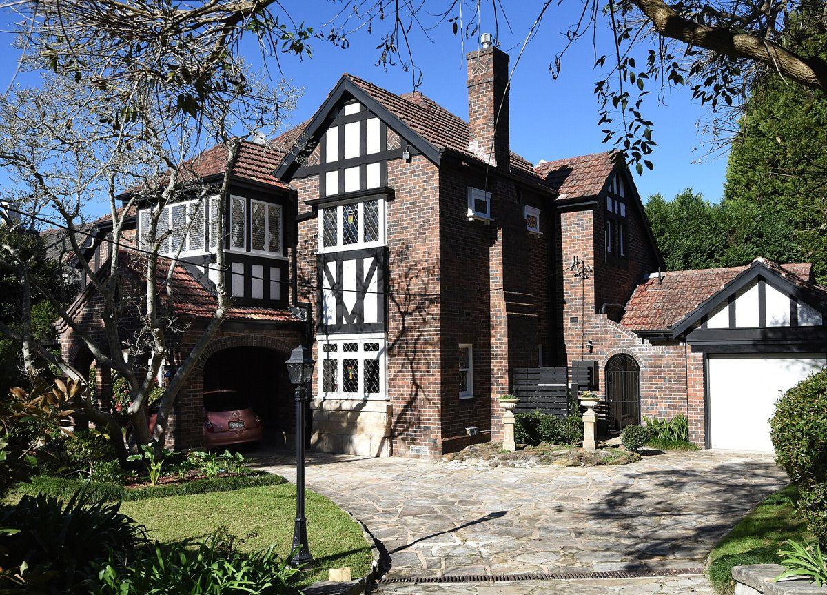 A two-storey Old English style house in Killara with a front garden and driveway